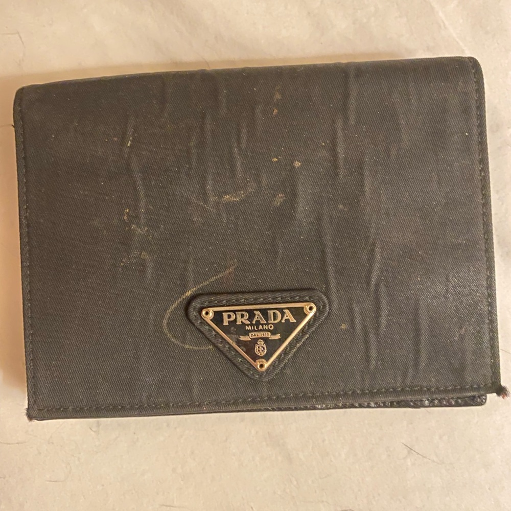 Unused Prada wallet that has some water damage - it may be able to be cleaned.